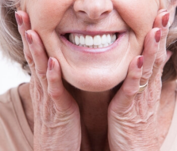 Senior woman with permanent dentures smiling with beautiful teeth
