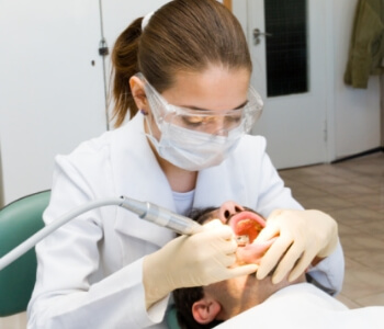 Female dentist working on patient mouth
