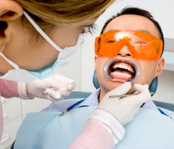 man with getting treatment for soft tissue damage from dentist