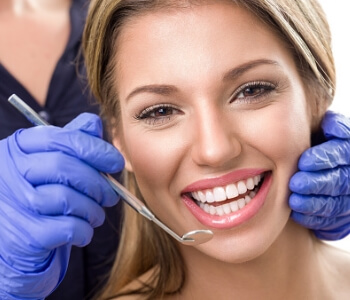 Woman smiling with beautiful teeth at dentis